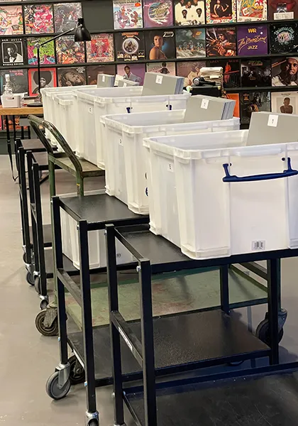 Picking trolleys lined up in a record warehouse